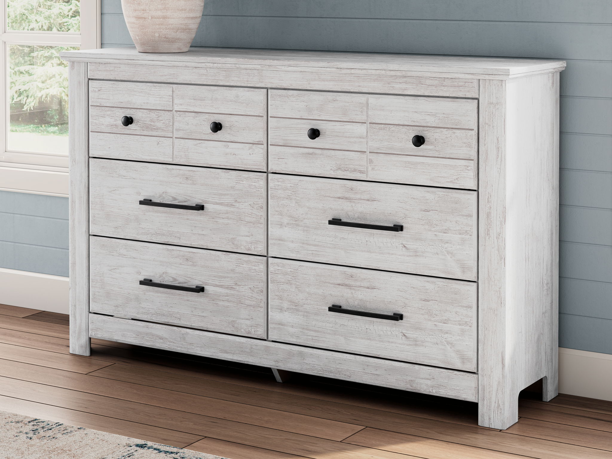 Whitewash six-drawer dresser with black bar pulls and a smooth top panel