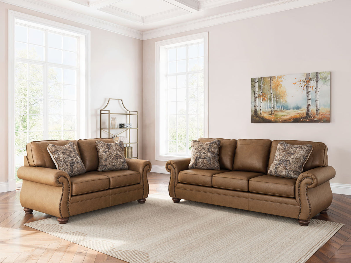 Dark brown living room seating set with patterned accent pillows on both pieces