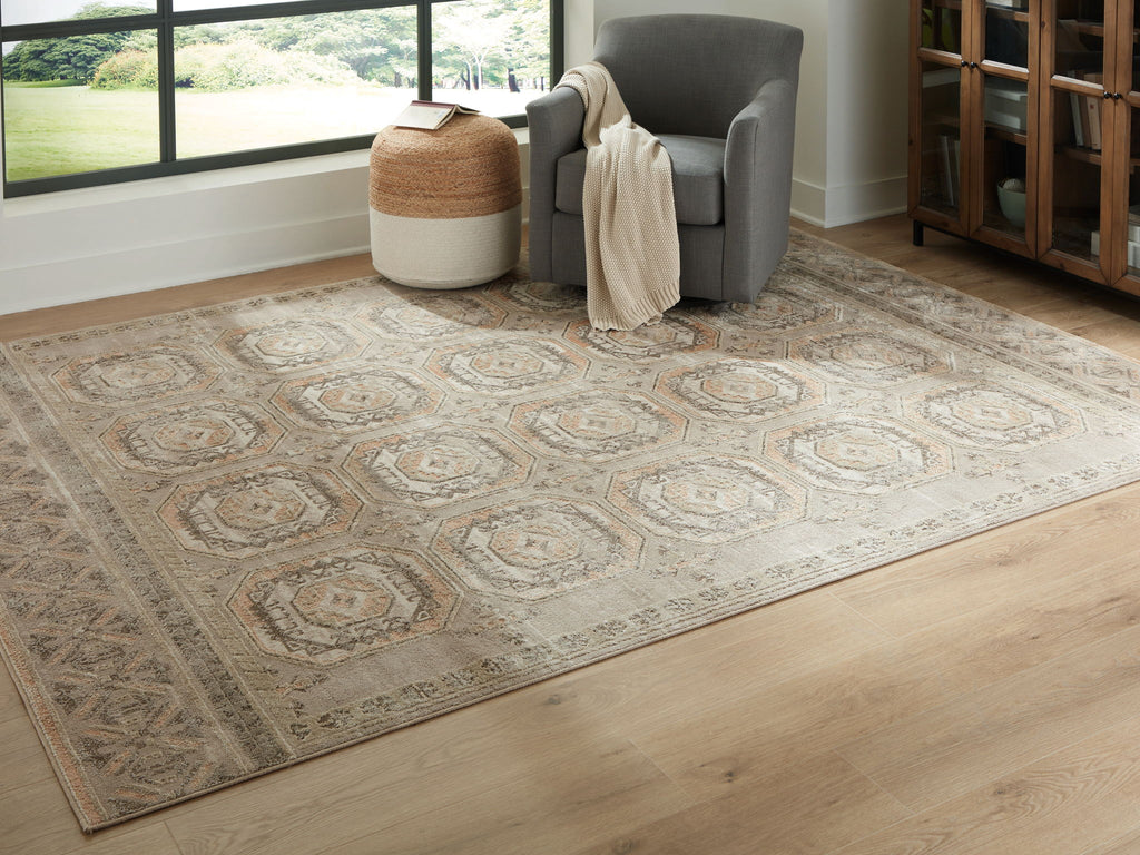 Beige and gray rug with distressed medallion pattern and wide border