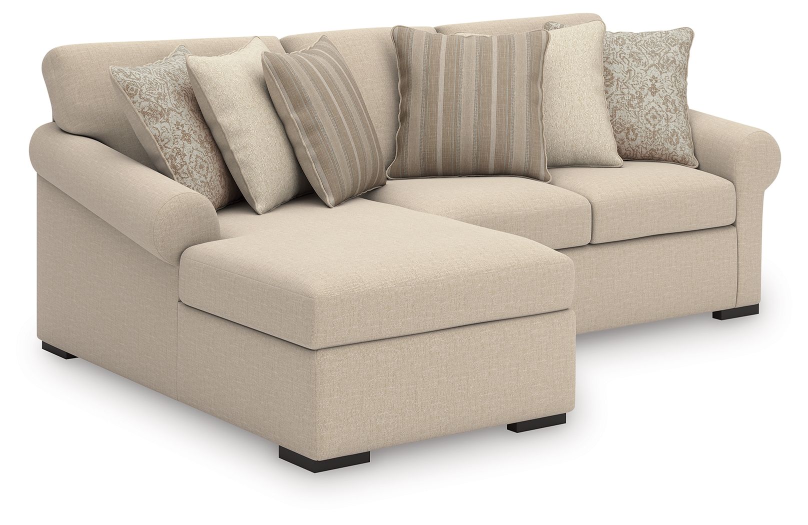 Light beige sectional sofa with chaise cushion and multiple striped accent pillows