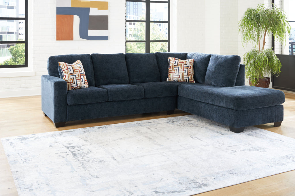 Dark blue corner chaise sectional sofa with geometric accent cushions