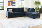 Dark blue corner chaise sectional sofa with geometric accent cushions