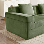Green corduroy sofa armrest and seat corner with ribbed fabric texture