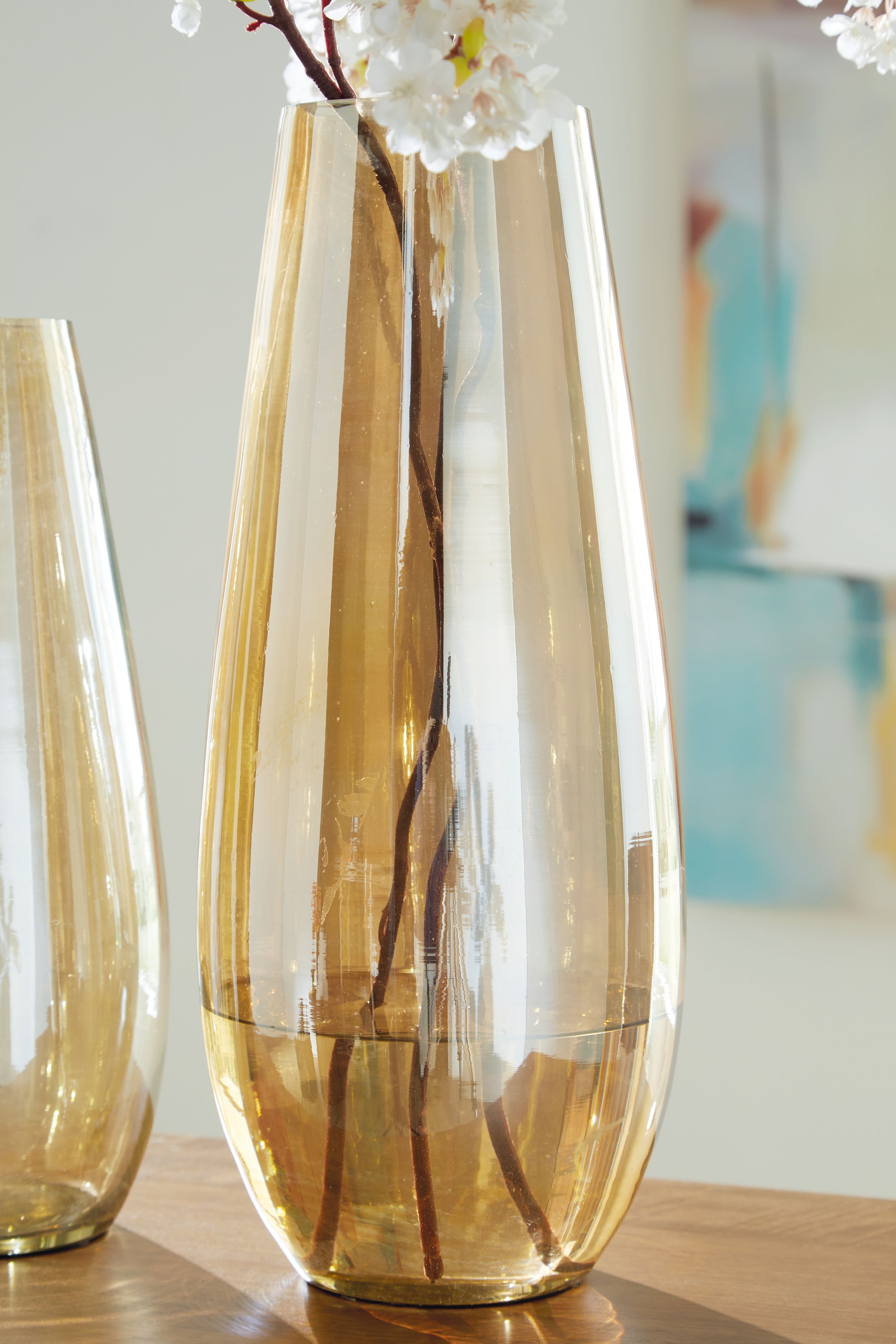 Tall amber glass vase with flared top and reflected vertical streaks