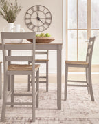 Dining chair and part of dining table with light wood seat and gray frame