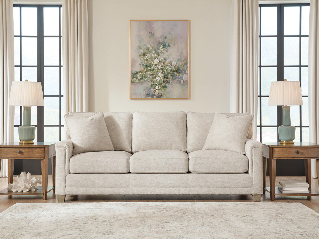Light beige sofa with four back pillows and three seat cushions, front view