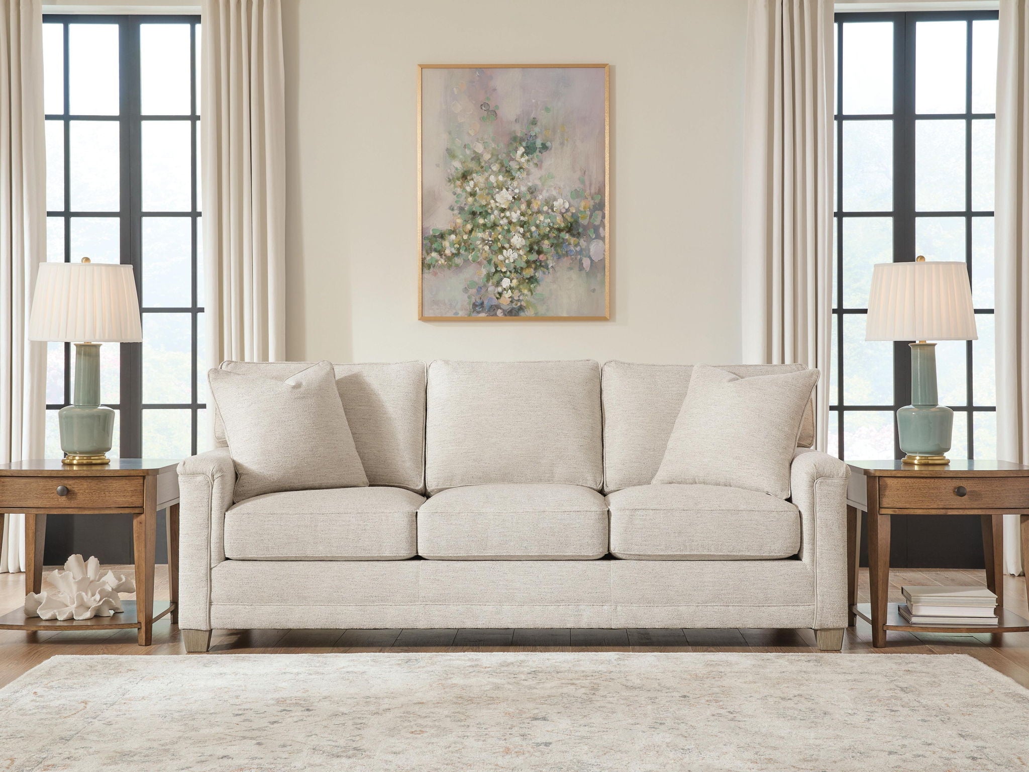 Light beige sofa with four back pillows and three seat cushions, front view