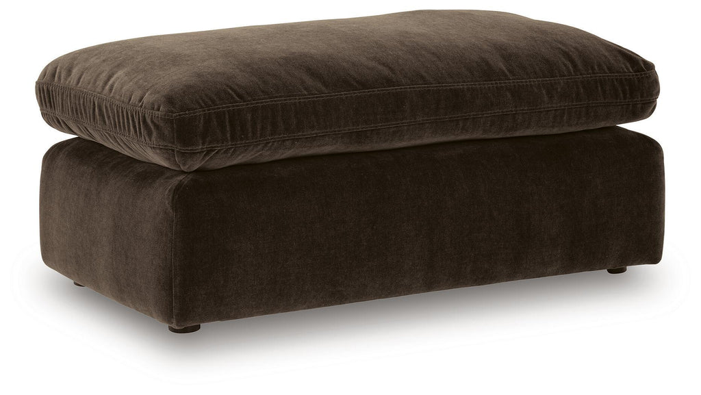 Dark brown upholstered ottoman with rounded top and short legs