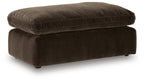Dark brown upholstered ottoman with rounded top and short legs