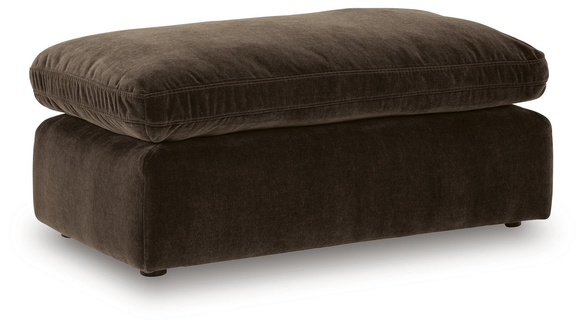 Dark brown upholstered ottoman with rounded top and short legs