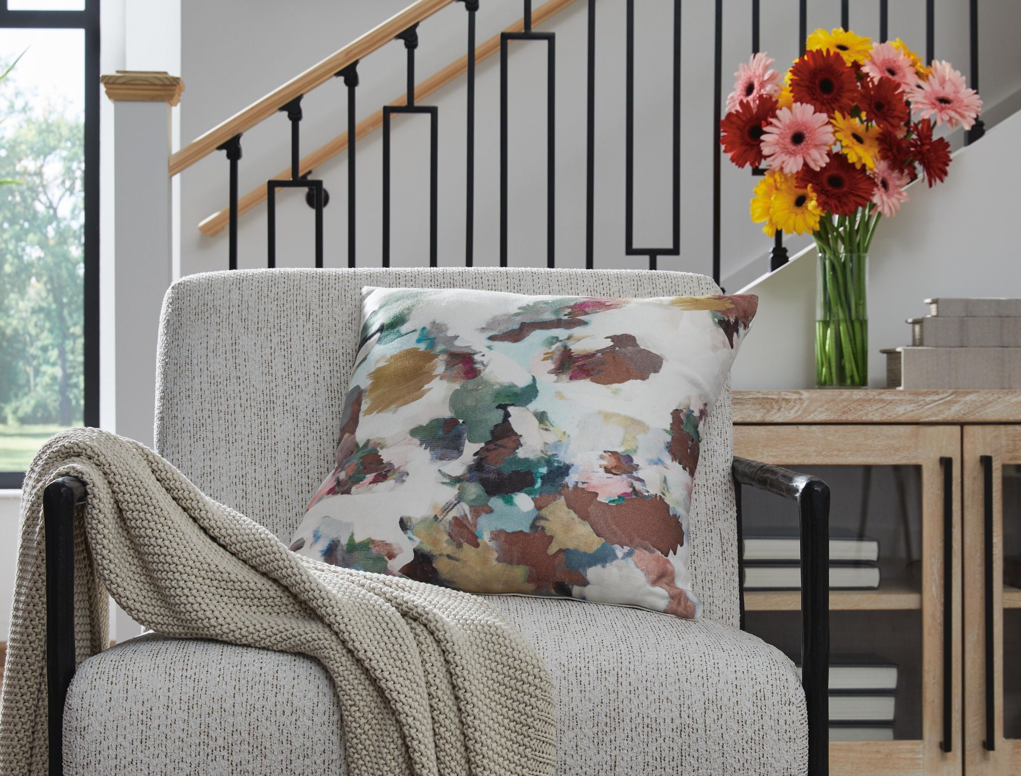 Herston square pillow with multicolor watercolor cover, styled on a sofa
