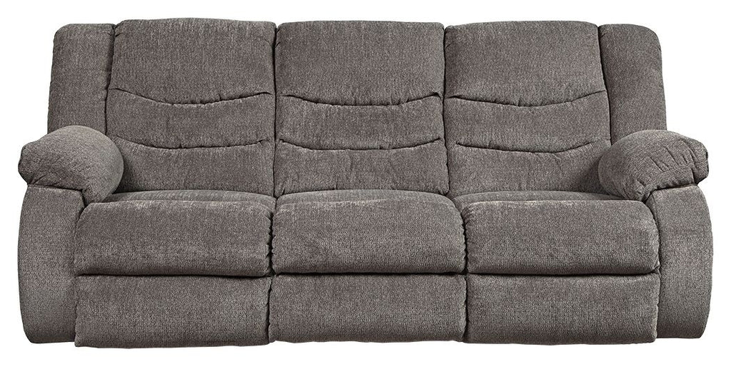 Gray reclining sofa with padded back cushions and rolled arms