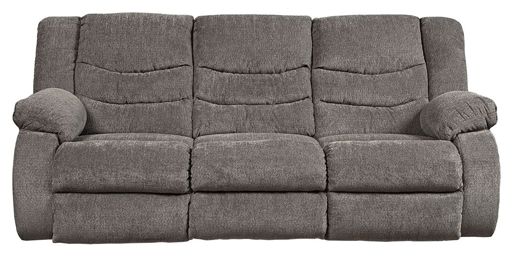 Gray reclining sofa with padded back cushions and rolled arms