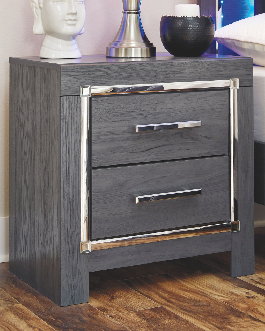 Gray nightstand with two drawers and chrome corner accents
