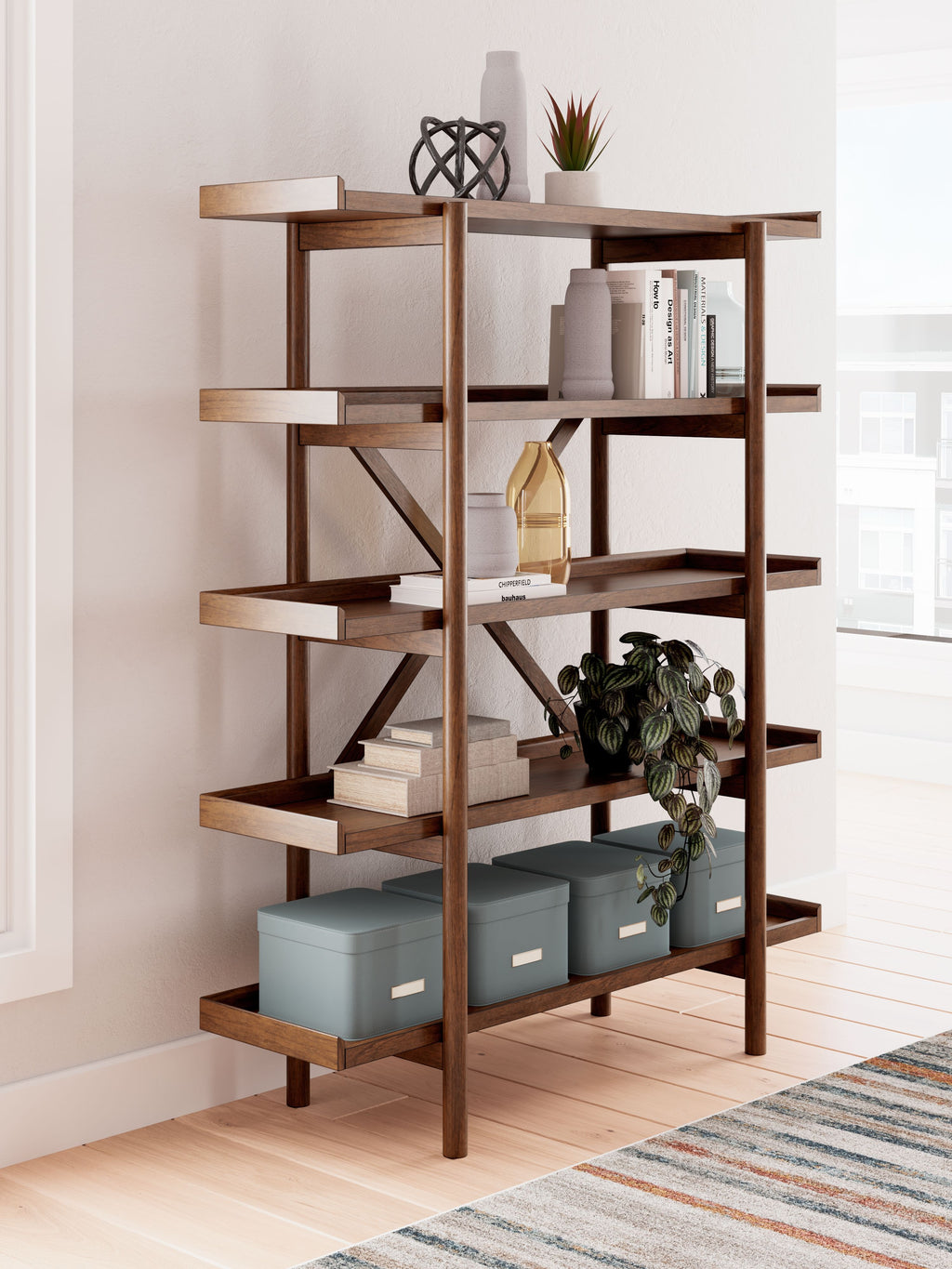 Brown wooden bookcase with multiple open shelves and X-style supports