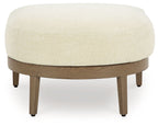 Round beige fabric ottoman with dark brown wooden legs
