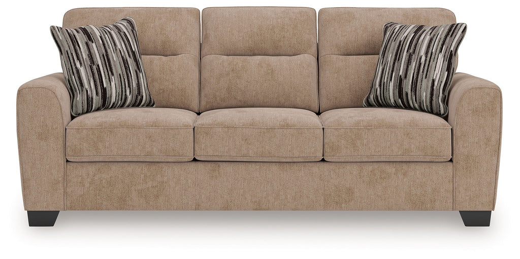 Light brown sofa with three seat cushions and two striped throw pillows