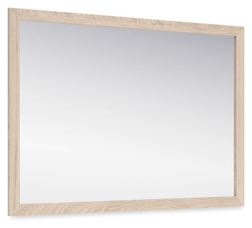 Tan bedroom mirror with wide rectangular frame