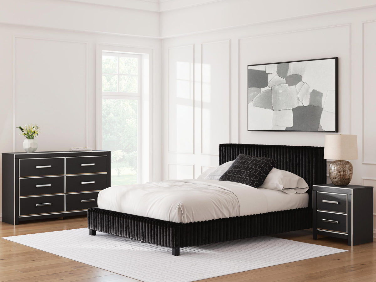 Black upholstered bed with two nightstands and matching dresser