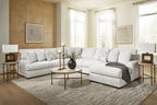 Light beige sectional sofa with chaise bed-like chaise section and patterned pillows