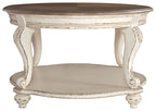 Oval cocktail table with white carved legs and brown wood top with lower shelf