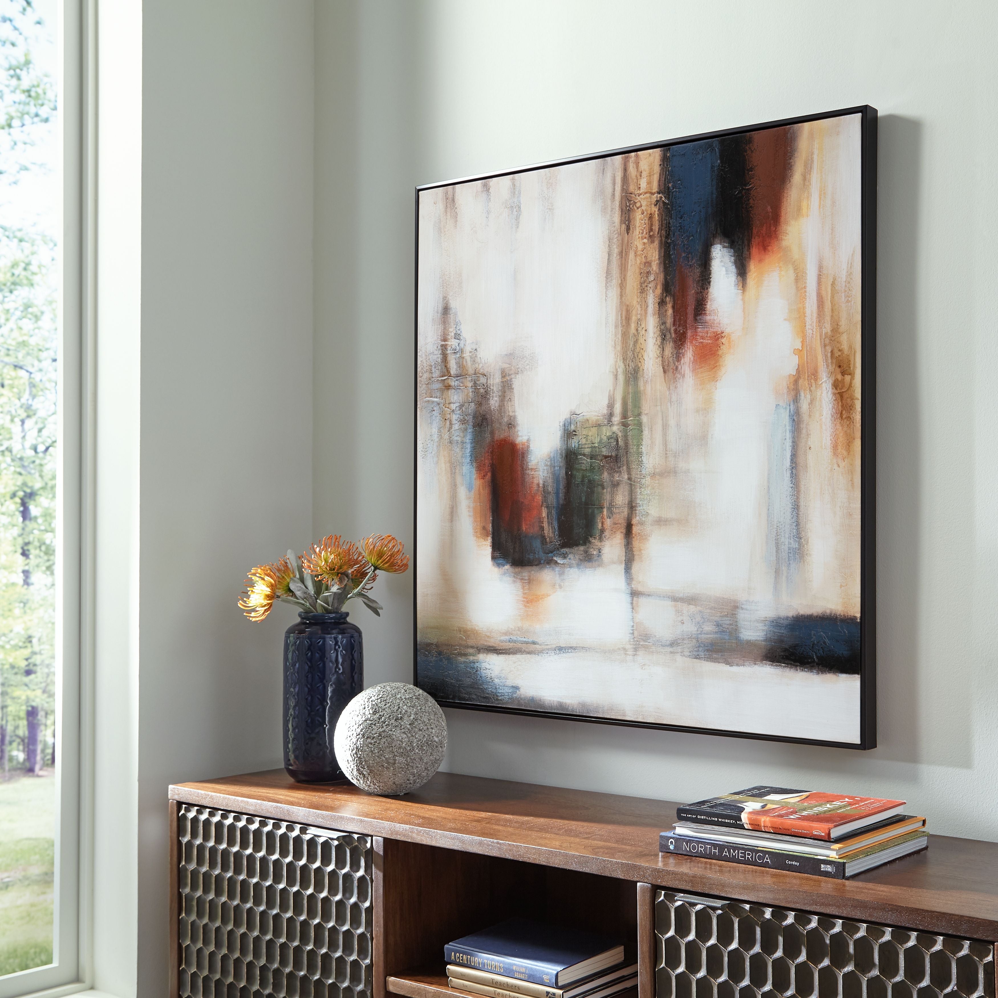 Framed abstract wall art with white, teal, and gold vertical brushwork.