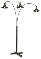 Black metal arc floor lamp with three dome shades and curved arms, standing base