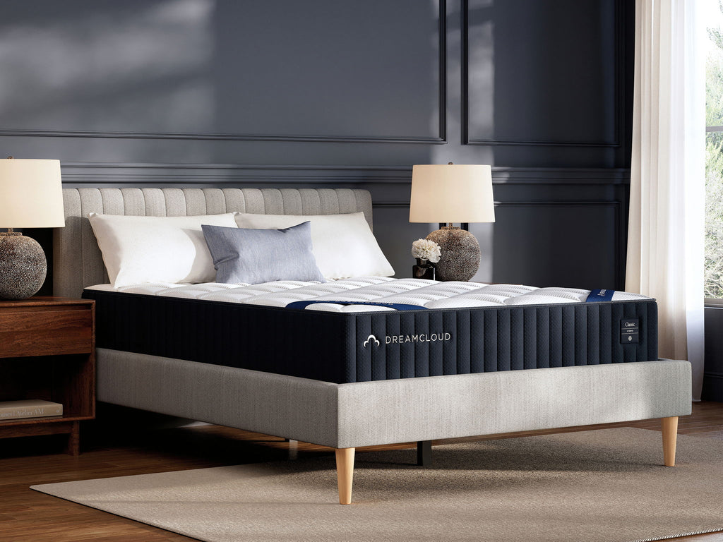 DreamCloud classic hybrid mattress on bed frame, black sides with white pillow top