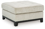 Beige oversized accent ottoman with tufted top and dark wooden legs