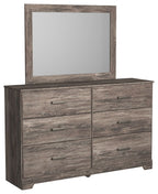 Gray dresser with mirror and six drawers, all featuring bar handles