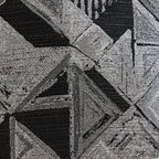 Black corduroy upholstery with vertical channel stitching and textured cushion surface