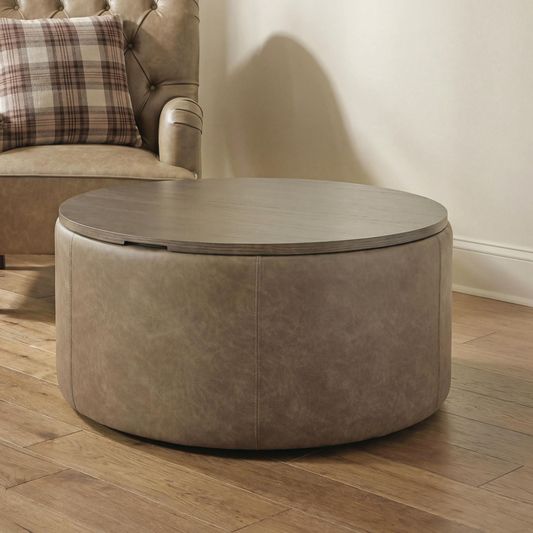 Round warm brown storage ottoman with smooth vinyl-look upholstery, closed lid