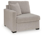 Grey corner chair with left-facing arm, upholstered fabric, square base feet