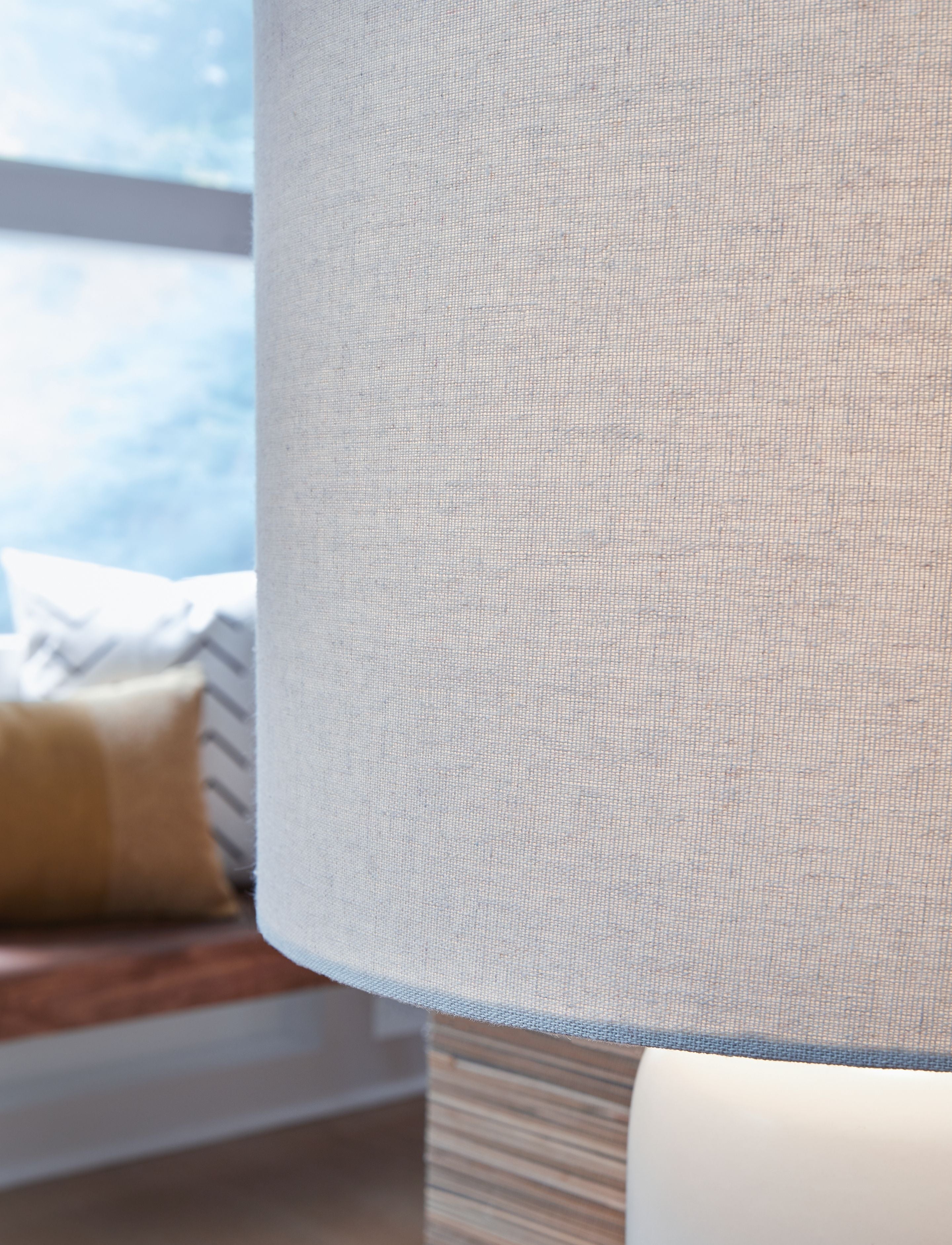 Ceramic table lamp with textured fabric shade and blue ceramic base
