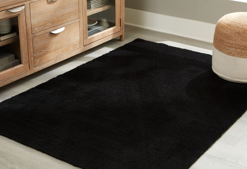 Anaben rug in black, rectangular shape with short low-pile surface