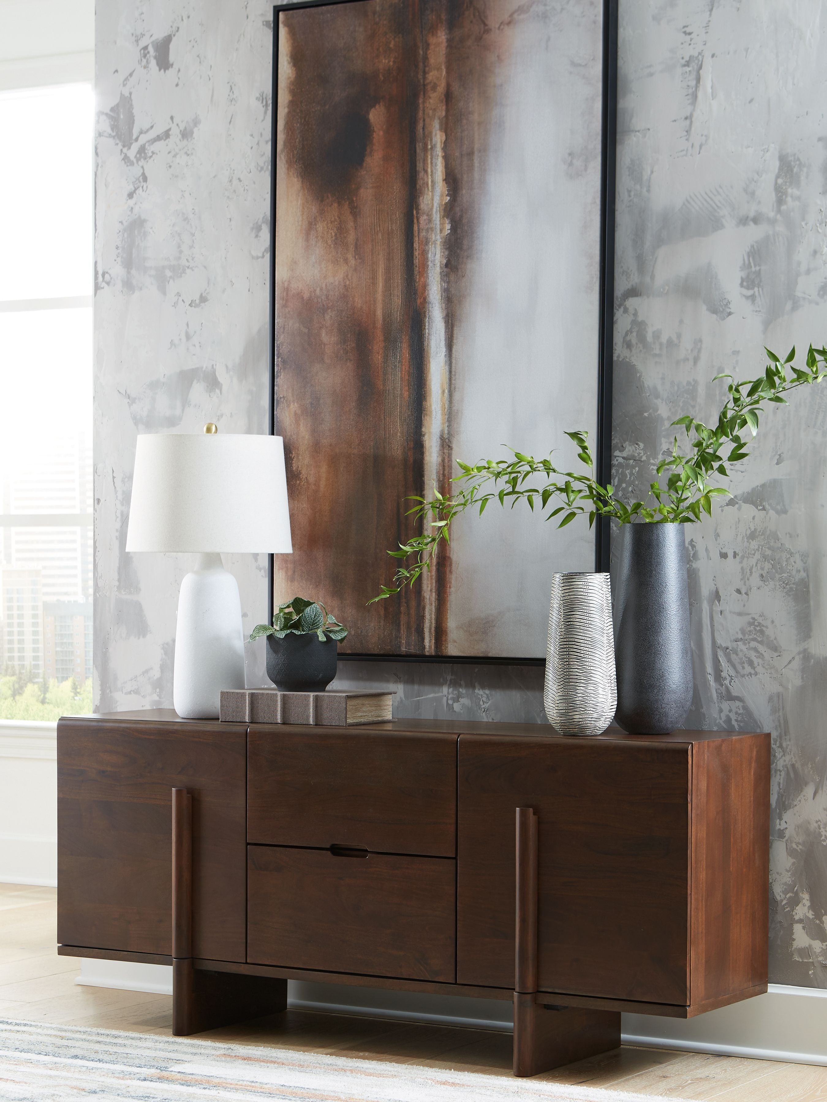 Medium brown accent cabinet with three drawers and lower doors, flat black hardware.
