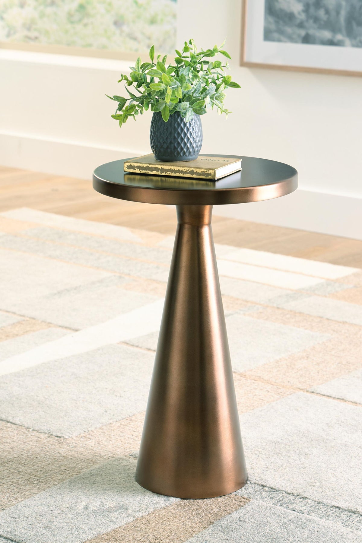 Round-top accent table with light bronze metal pedestal base