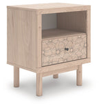 Tan wood one-drawer night stand with open shelf and floral drawer front, front view