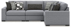 Gray sectional sofa with corner chaise and patterned throw pillows