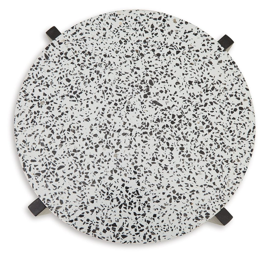 Round accent table top with white speckled surface and black corner pads