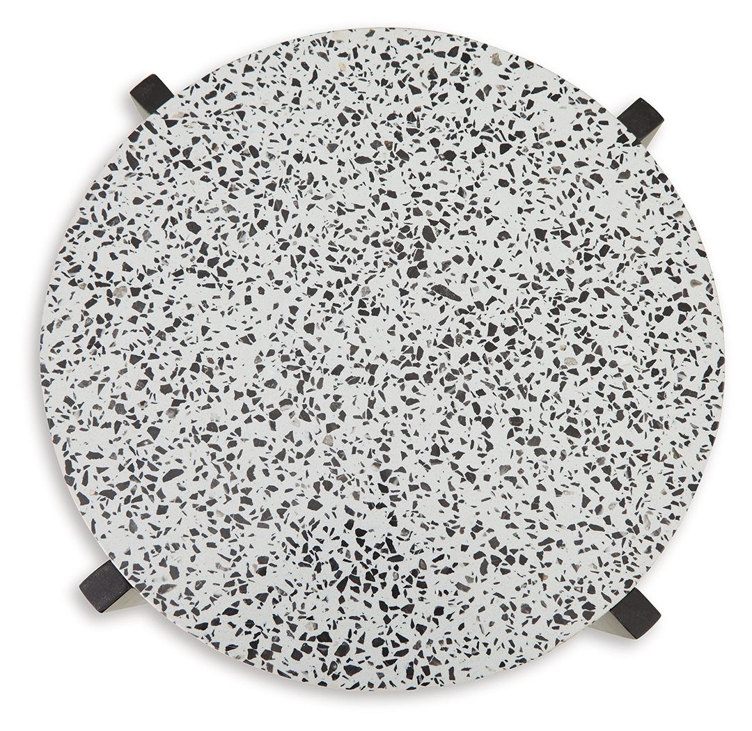 Round accent table top with white speckled surface and black corner pads