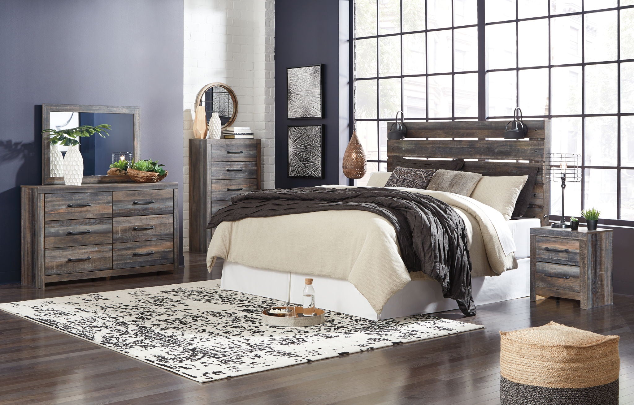 Bedroom furniture set in dark gray with beige bedding, bed, nightstand, dresser, mirror