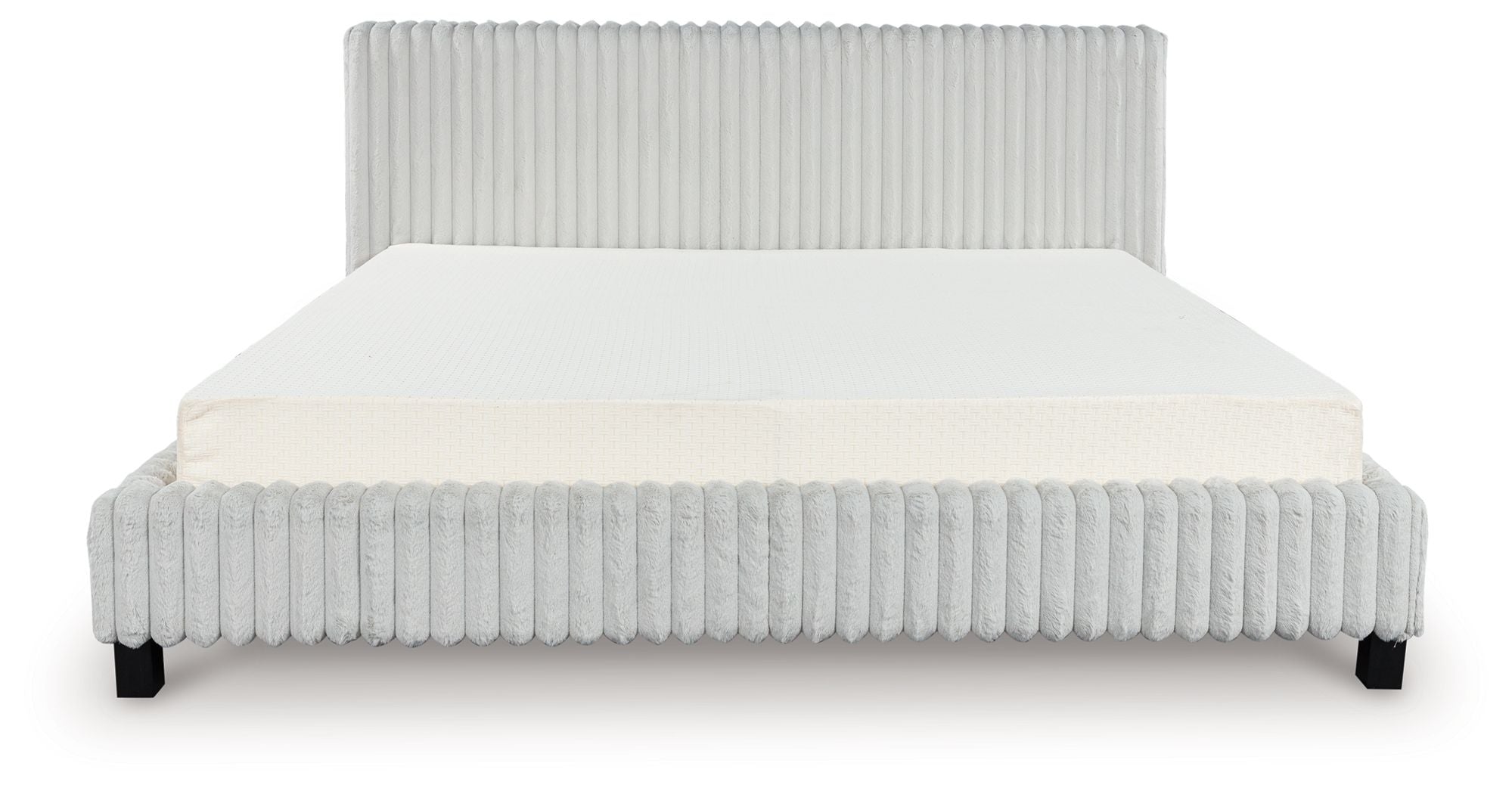 Upholstered bed with light ribbed headboard and sides, white mattress