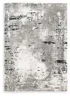 Gray area rug with mottled distressed pattern and black speckling