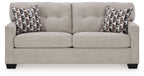 Pebble sofa sleeper with two patterned throw pillows and clean, cushioned seat