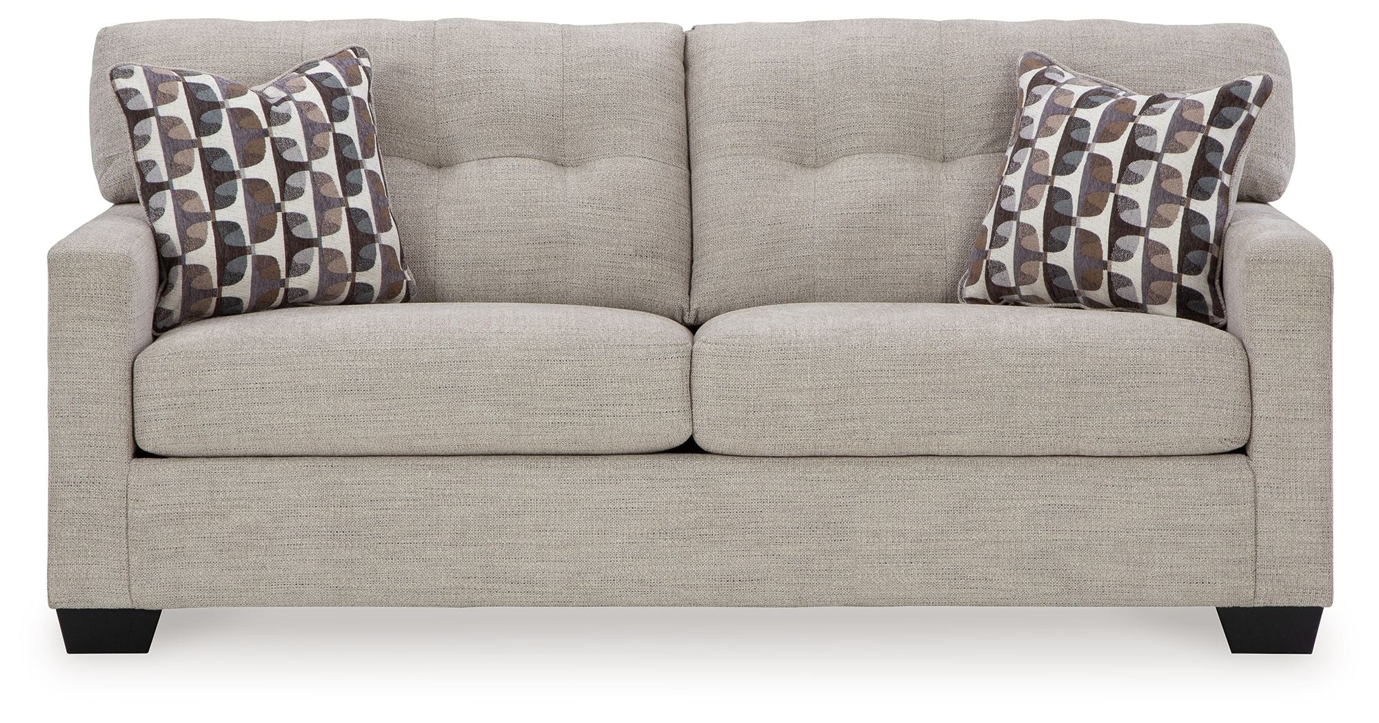 Pebble sofa sleeper with two patterned throw pillows and clean, cushioned seat