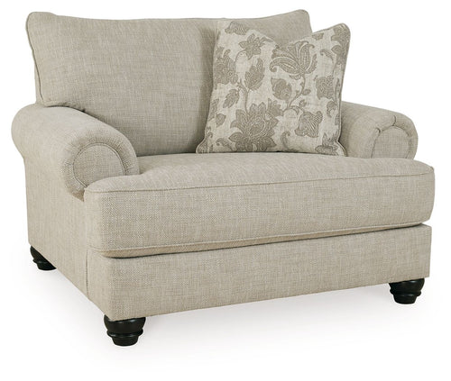Light gray linen-style armchair with rounded arms, two pillows, and dark feet