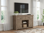Light brown wood TV stand with drawers and cabinet doors, styled in a living room.