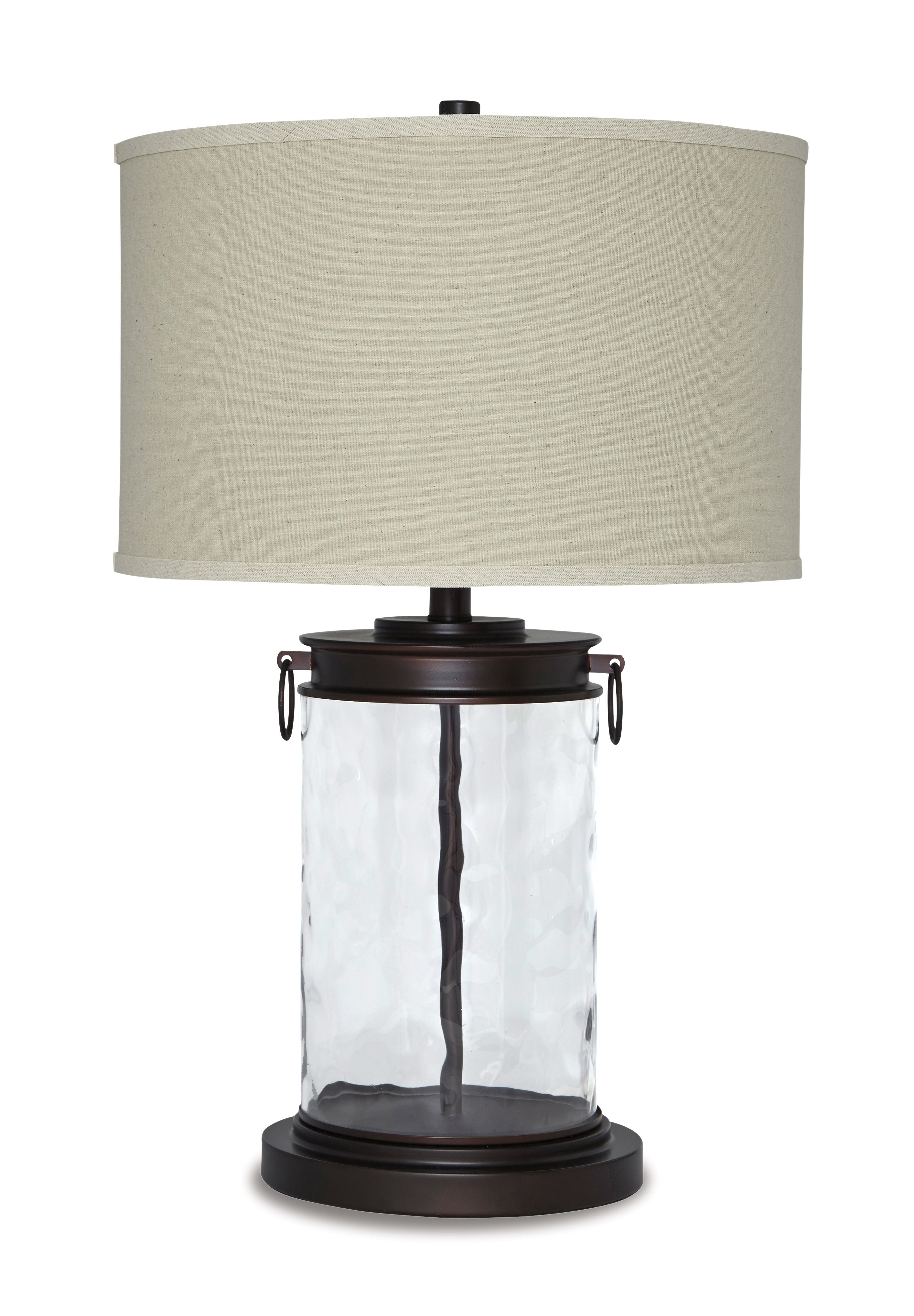 Table lamp with clear glass body, dark bronze finish base, and beige fabric shade