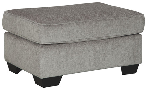 Upholstered light gray ottoman with cushioned top and block legs